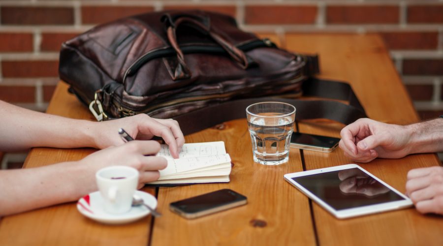 Two people are sitting at a table talking