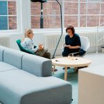 2 Woman sitting in couch talking