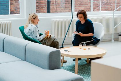 2 Woman sitting in couch talking