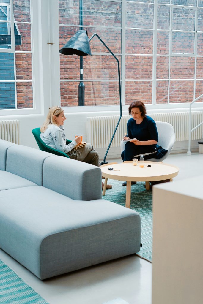 2 Woman sitting in couch talking