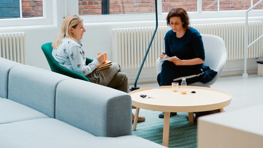 2 Woman sitting in couch talking