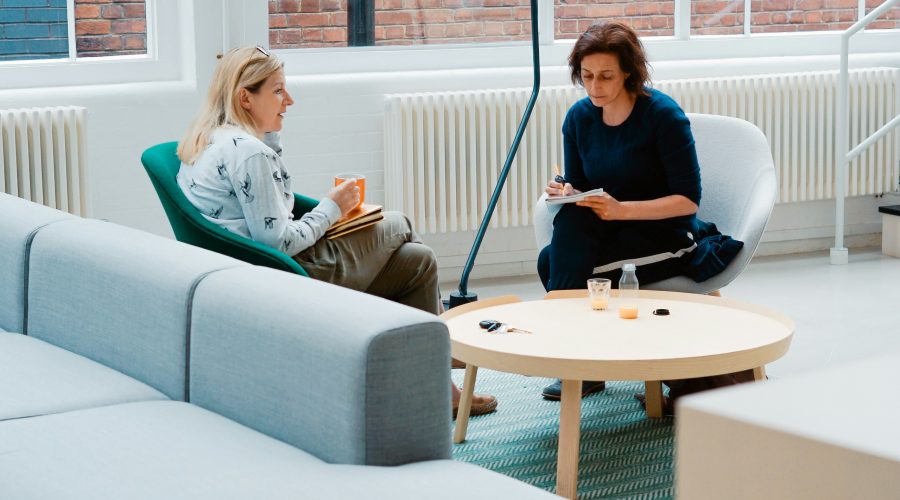 2 Woman sitting in couch talking