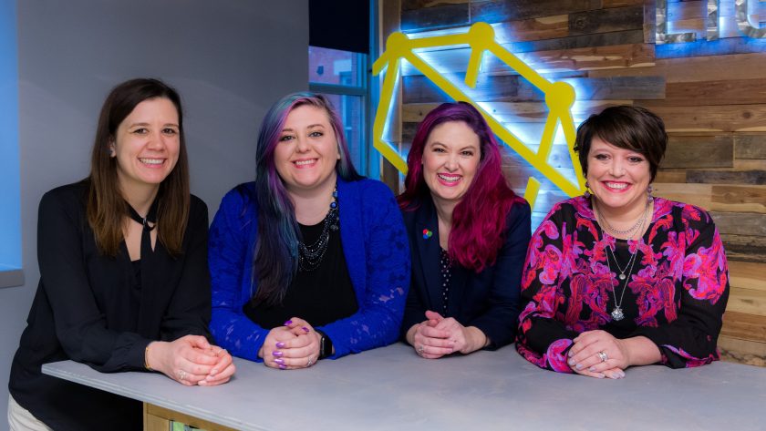 4 Woman are sitting and smiling at the camera